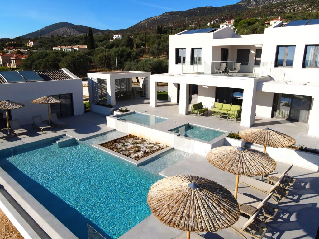 Aerial view of Villa Insieme's pools and terrace in Mousata, Kefalonia