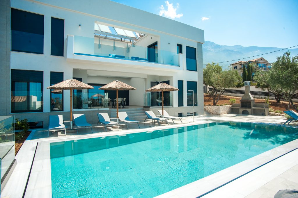 Villa Azzurro three-storey exterior with pool and mountain backdrop, Kefalonia