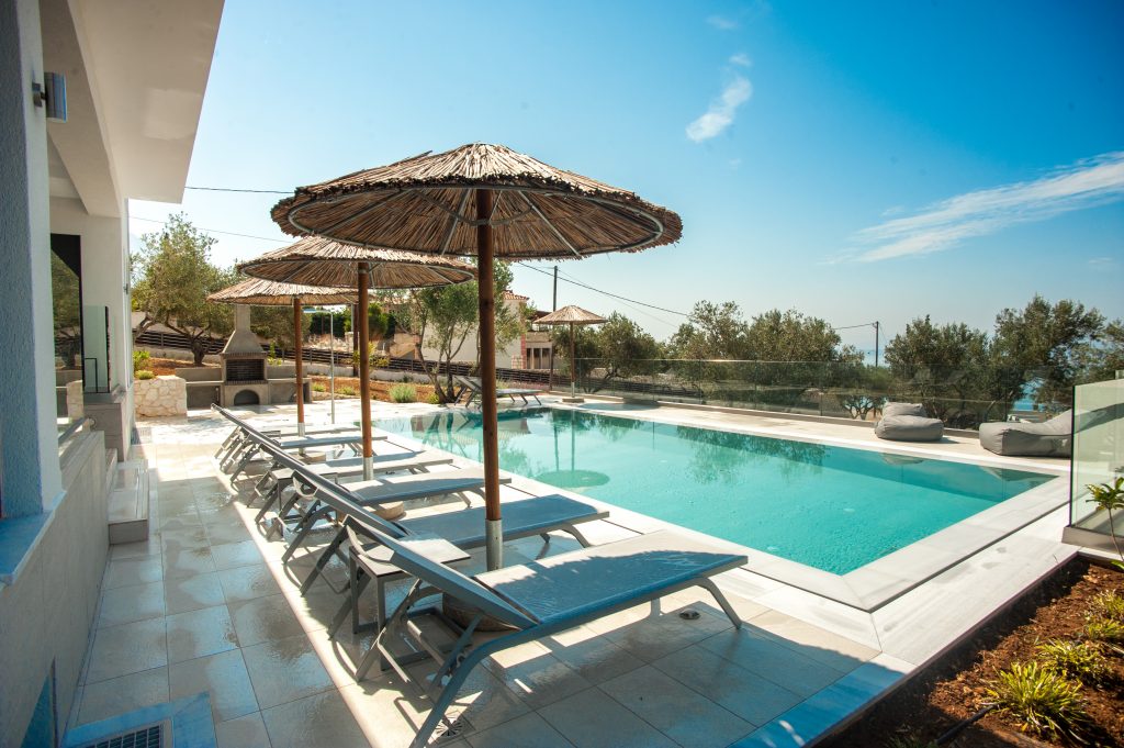 Villa Azzurro poolside terrace with umbrellas, Kefalonia