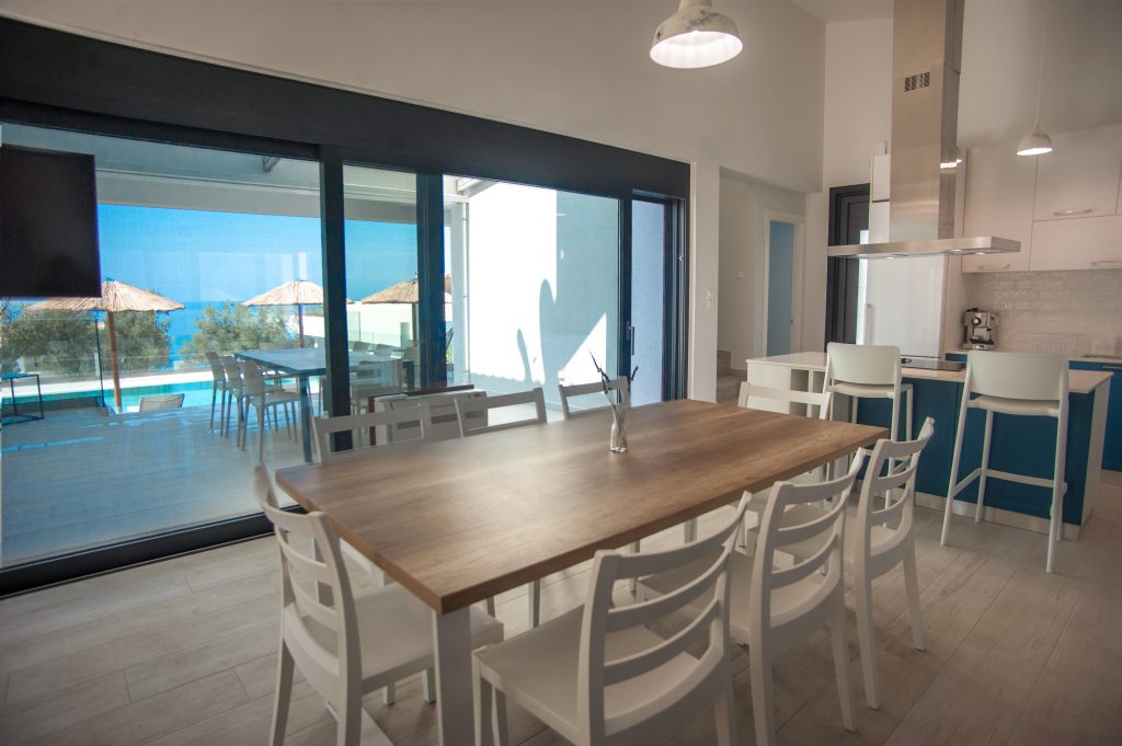 Villa Azzurro dining area with sliding doors onto the pool terrace, Kefalonia