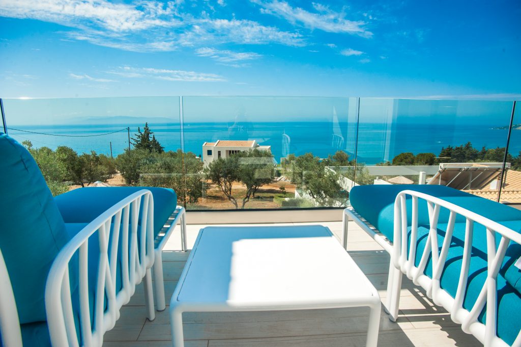 Villa Azzurro sea-view terrace with olive trees and lounge chairs, Kefalonia
