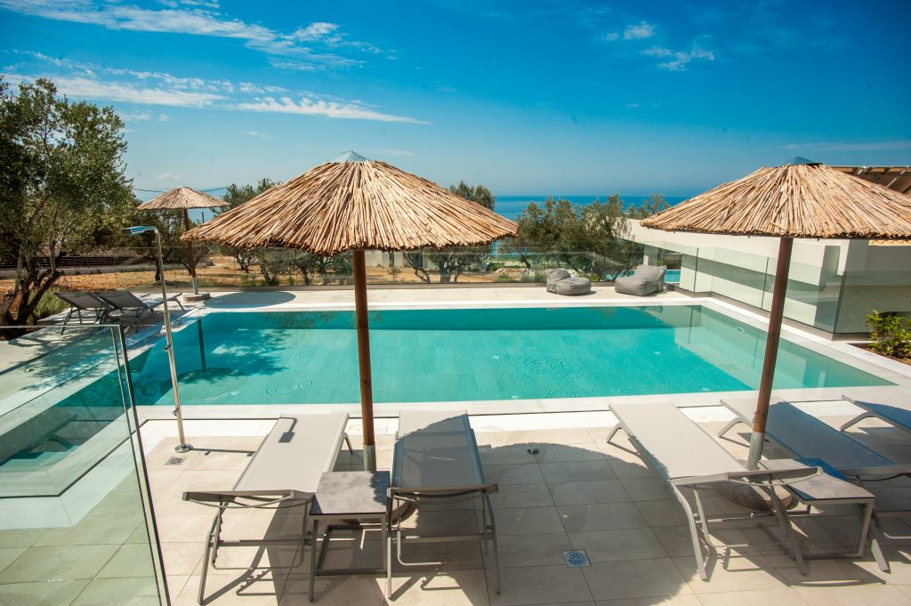 Villa Azzurro pool terrace with umbrellas and sun loungers, Kefalonia