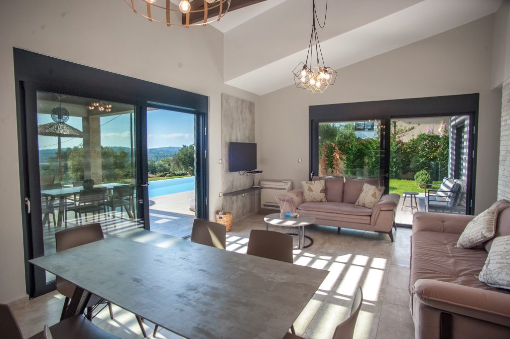 Villa Carisma living and dining area opening onto the pool terrace, Kefalonia