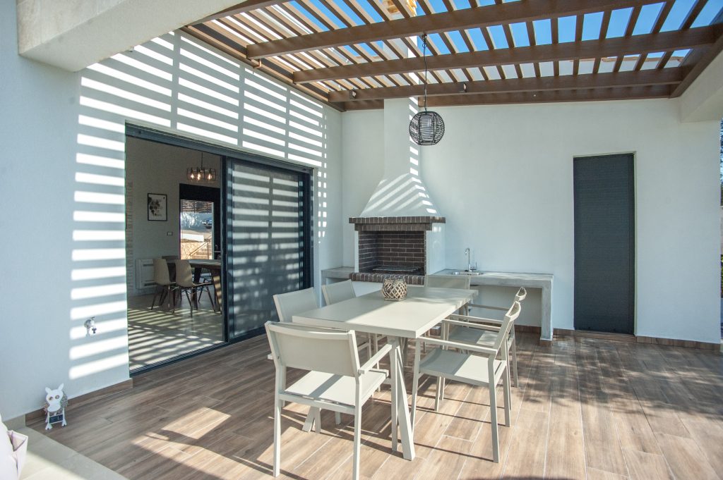 Villa Carisma covered outdoor dining area under a pergola, Kefalonia