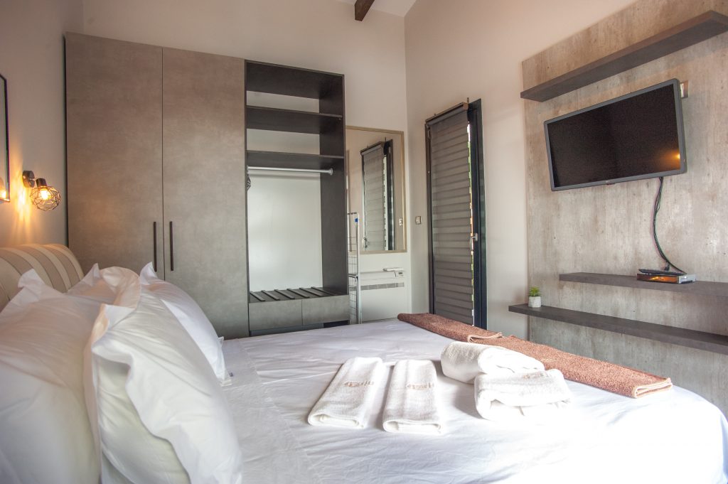 Villa Carisma double bedroom with fitted wardrobe and wall-mounted TV, Kefalonia