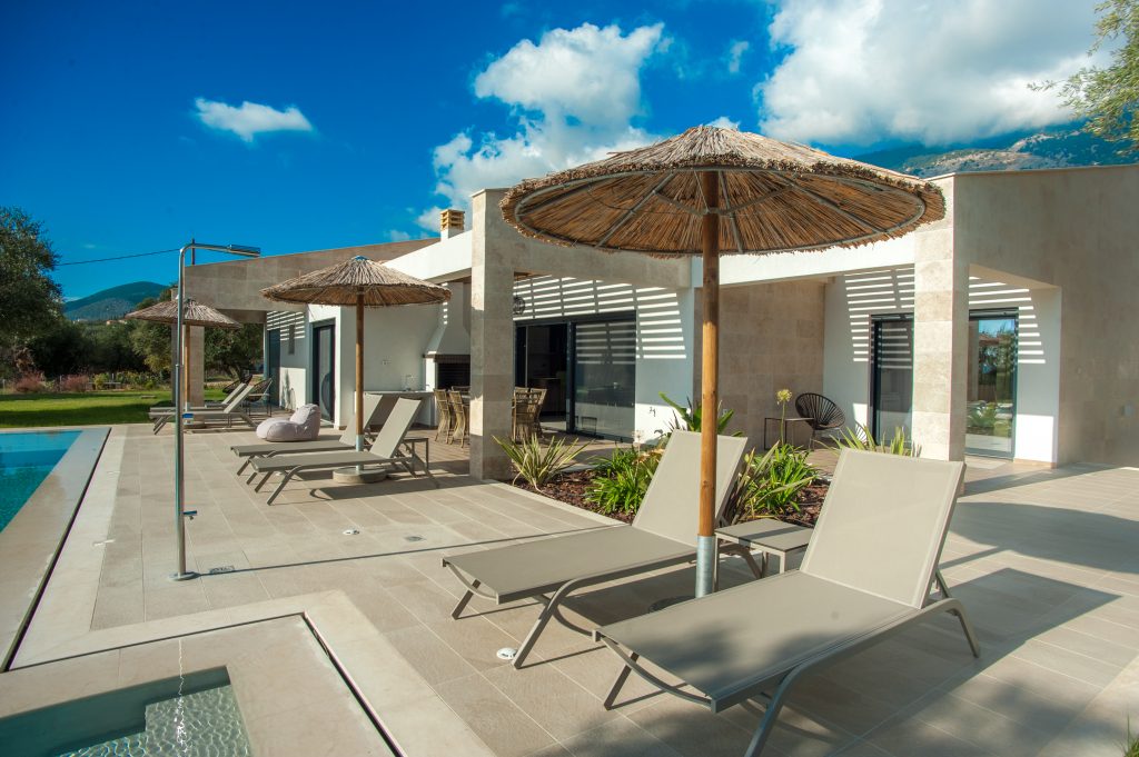 Poolside terrace with umbrella and loungers, Villa Arte, Kefalonia