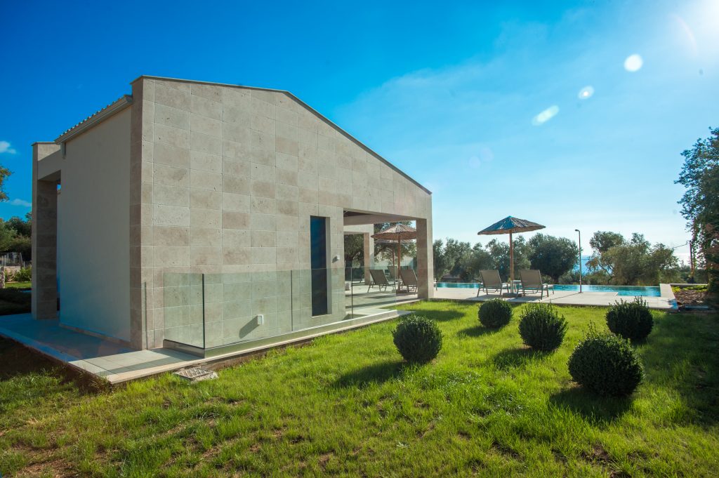 Villa Carisma exterior with grass gardens and pool, Kefalonia