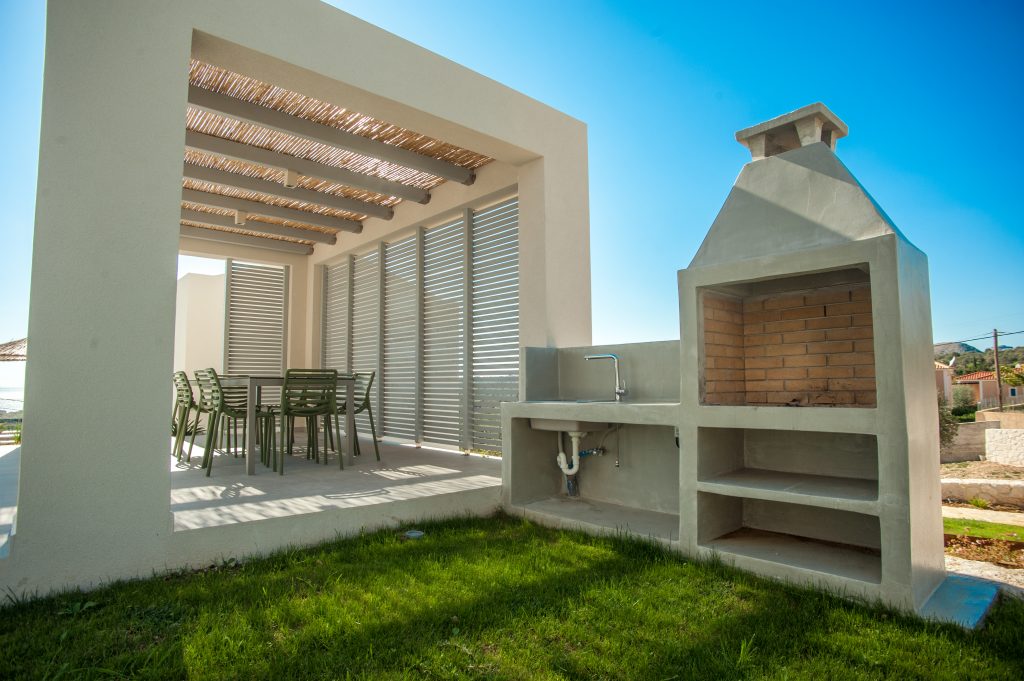 Villa Insieme outdoor dining terrace with BBQ station under a pergola, Kefalonia