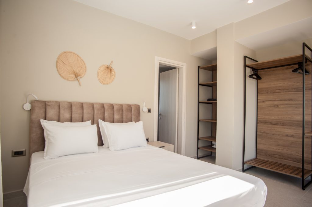Villa Insieme bedroom with open wardrobe and fitted headboard, Kefalonia