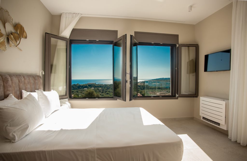 Villa Insieme bedroom with sea views through wide windows, Kefalonia