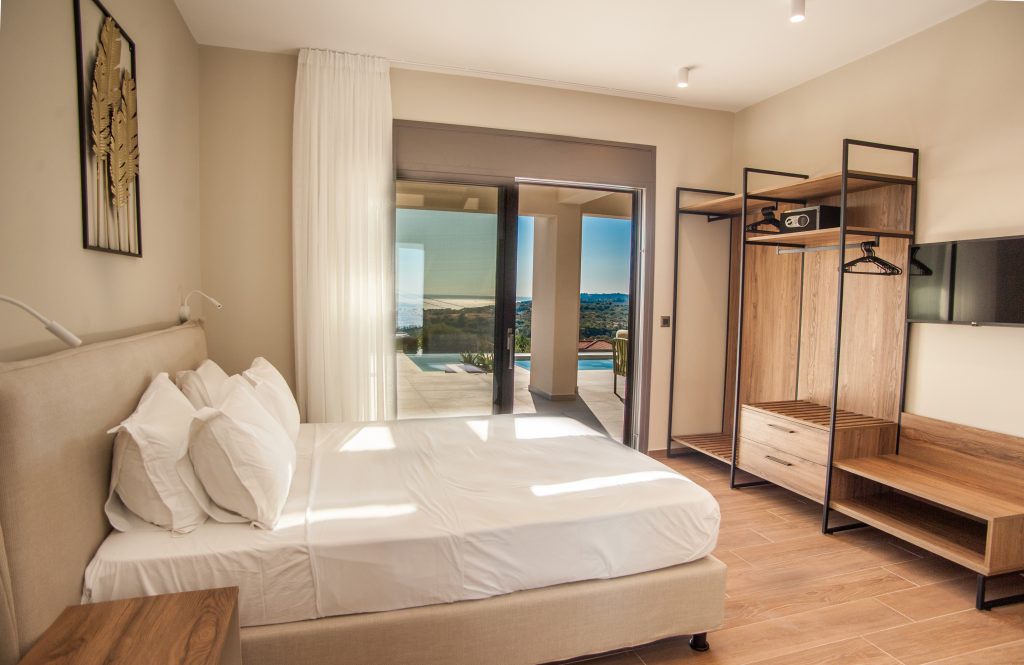 Villa Insieme bedroom with open wardrobe and pool-view terrace, Kefalonia