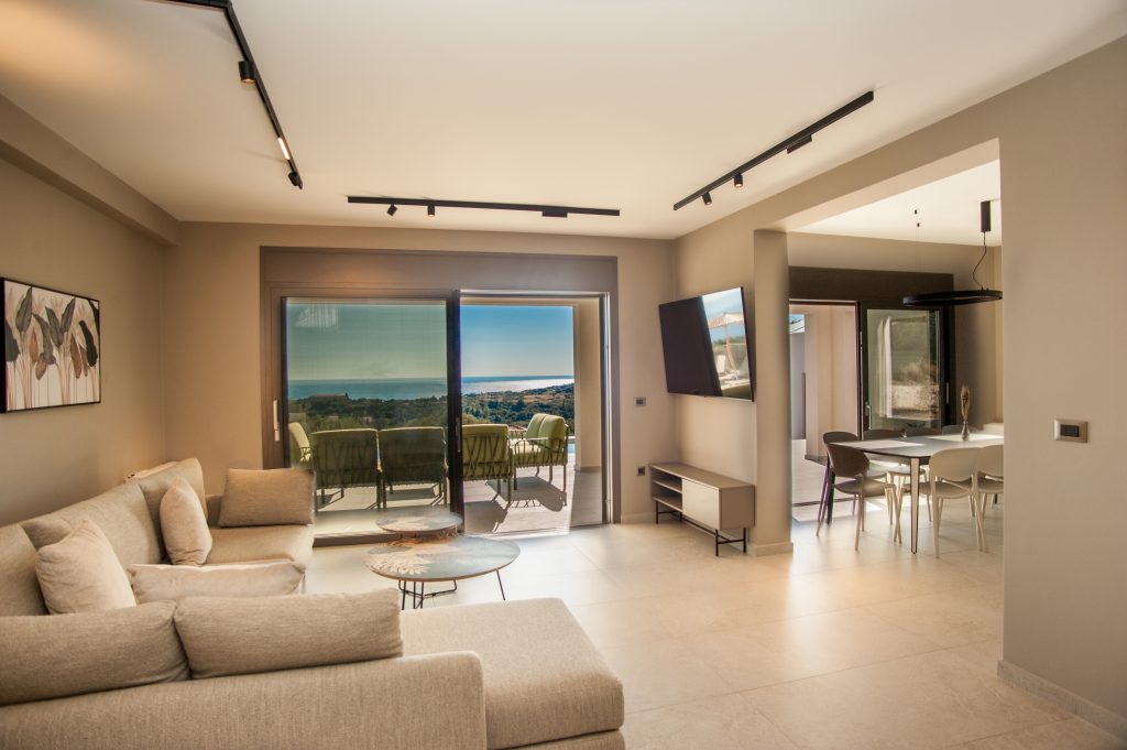 Villa Insieme living and dining area opening onto the sea-view terrace, Kefalonia