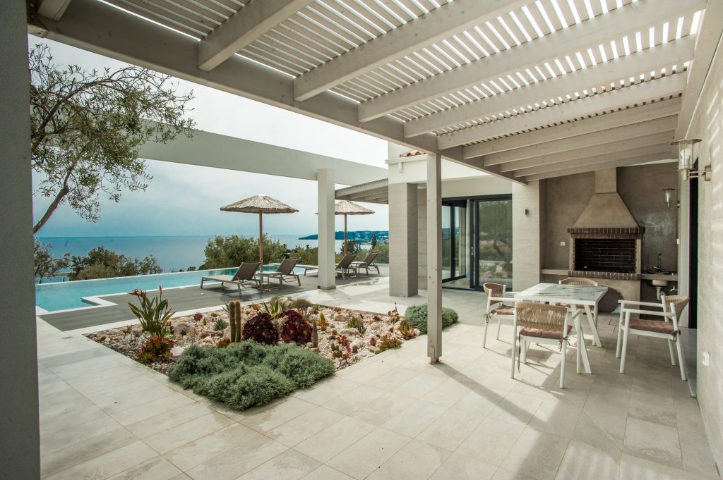Villa Bambola covered outdoor dining area with sea views and BBQ, Kefalonia